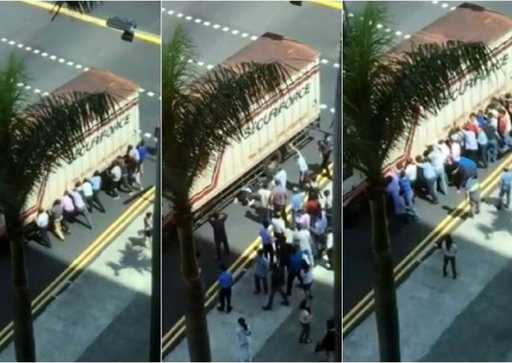 Singapore: passers-by rush to help man pinned under truck