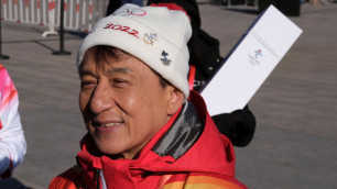 Jackie Chan carries the 2022 Olympic flame across the Great Wall